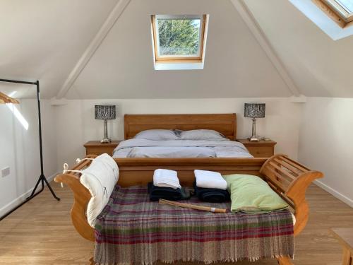 哈羅蓋特的住宿－Coach house Harrogate，一间卧室配有一张带两把椅子和两盏灯的床。