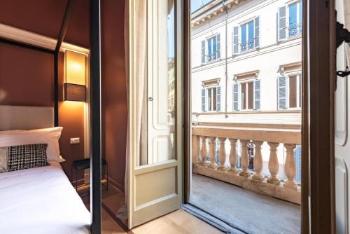 a bedroom with a view of a balcony at The Couper Sant'Andrea in Milan