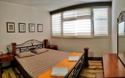 Schlafzimmer mit einem Bett und einem Fenster in der Unterkunft Promenade suite in Kotor