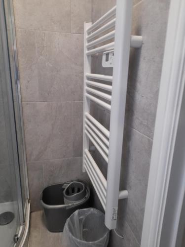 a refrigerator with a trash can in a bathroom at Ds Apartments in Blackpool