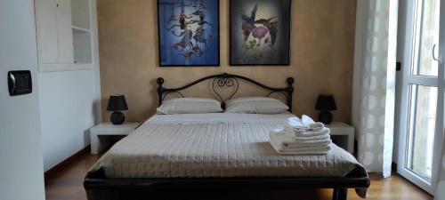 チンクアレにあるVilletta Marina Verde Cinqualeのベッドルーム1室(ベッド1台、タオル2枚付)