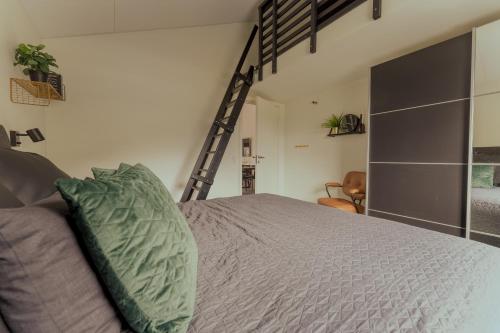 a bed with a green pillow in a bedroom at Luxurious & Unique Villa / Nature / Beach / Hiking in Tjørnuvík
