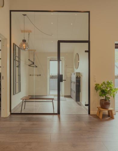 a pivot door in a room with a potted plant at Luxurious & Unique Villa / Nature / Beach / Hiking in Tjørnuvík