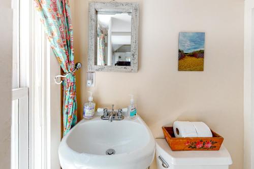 a bathroom with a sink and a mirror at Toast of P-town in Provincetown