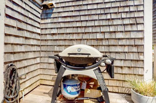 a grill sitting on a patio next to a wall at Toast of P-town in Provincetown