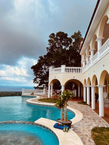a resort with a swimming pool and a building at El Castillo Tropical in Cabrera