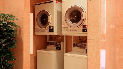 three washing machines and a washer and dryer in a room at Toyoko Inn Aomori Ekimae in Aomori