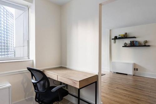 a desk and a chair in a room with a window at 1109-Extra LG-King Bed-1 Free Park-Fast WiFi-DTW in Atlanta