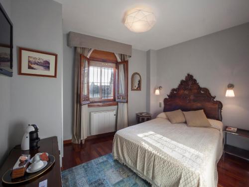 a bedroom with a large bed and a window at Almunia de San Miguel in Toledo