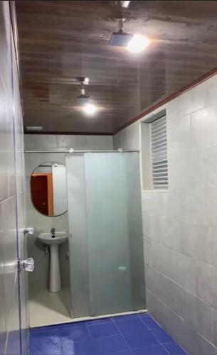 a bathroom with a shower with a sink and a toilet at Hotel Suit Esmeralda in Girardot