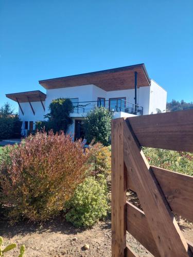 a wooden fence in front of a house at Callihue Lodge in Santa Cruz