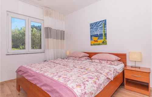 a bedroom with a large bed and a window at Stunning Apartment In Rogoznica With House Sea View in Rogoznica