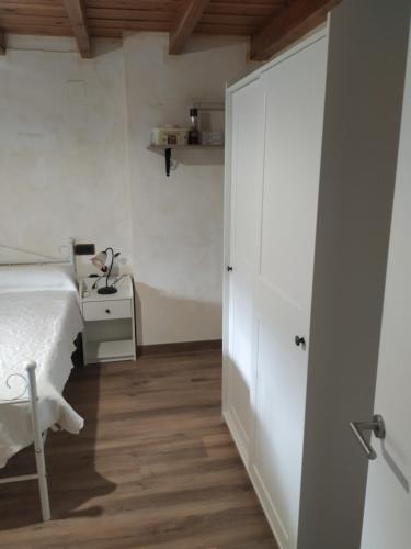 a bedroom with a bed and a table and a door at "Apartamento Peña Sagra" in San Mamés