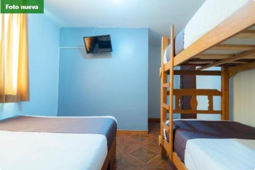 Una cama o camas en una habitación de Hostal Las Fresas Lima Airport