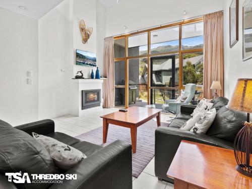 a living room with a couch and a table at Tomarlin Views 2 in Thredbo