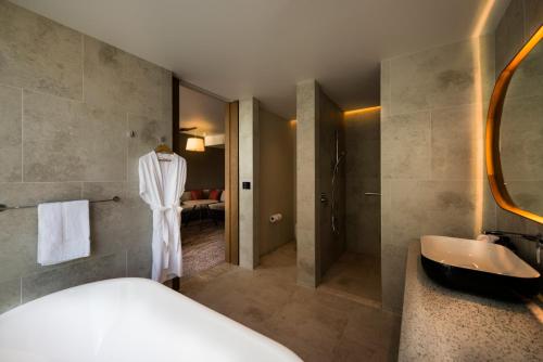 a bathroom with a bed and a sink at Crowne Plaza Hobart by IHG in Hobart
