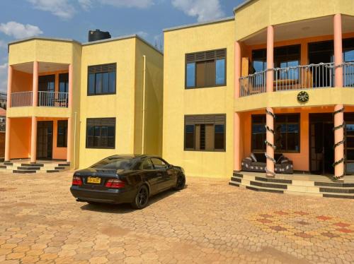 a car parked in front of a building at The Mugabis Spacious Private Room in Kigali