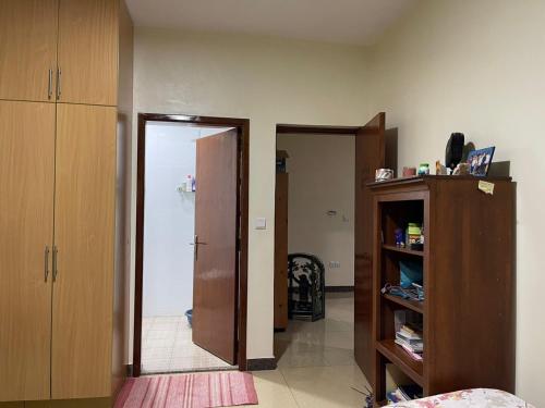 a room with a door open to a room with a room at The Mugabis Spacious Private Room in Kigali