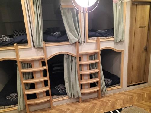 a group of bunk beds in a room at bnb plus Ueno Park Female only in Tokyo