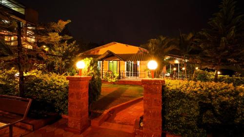 a house with lights in the yard at night at Lifeline Villas - Marvel Valley View 5Bhk With Private Pool,Surrounded by strawberry farms in Mahabaleshwar