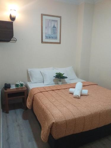 a bedroom with a large bed with white pillows at Hentian Hotel Kajang in Kajang