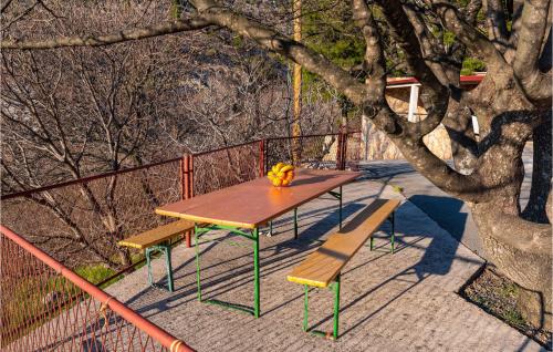 a picnic table with a pumpkin and two benches at 2 Bedroom Amazing Apartment In Modric in Rovanjska