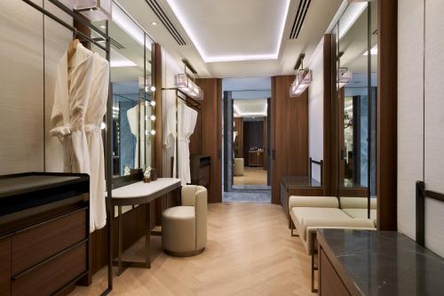 a dressing room with a vanity and a mirror at Centara Grand At CentralWorld in Bangkok