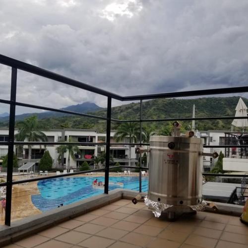 a view of the pool from the balcony of a hotel at Hermoso apartasol en santafe de Antioquia. in Santa Fe de Antioquia