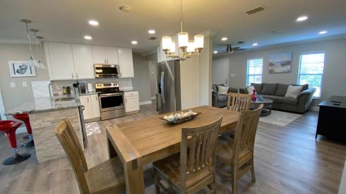 a kitchen and living room with a wooden table and chairs at Waterfront Hernando beach house on deep water canal w/dock, fishing, kayak in Hernando Beach