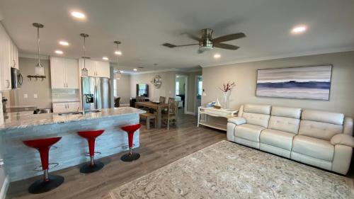 a kitchen and living room with a couch and a bar at Waterfront Hernando beach house on deep water canal w/dock, fishing, kayak in Hernando Beach
