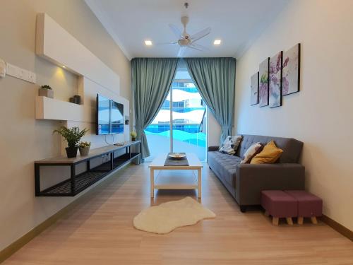 a living room with a couch and a table at The Wave Suites Melaka in Melaka