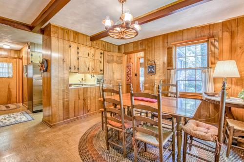 a dining room with wood paneling and a table and chairs at Dan Jones in Waynesville