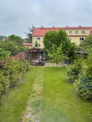 a yard with a house in the background at Lorin Prestige Apartament in Elblag