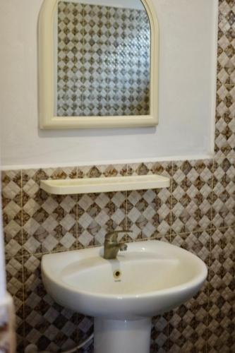 a bathroom with a white sink and a mirror at Freedom Beach Arugam Bay in Arugam Bay