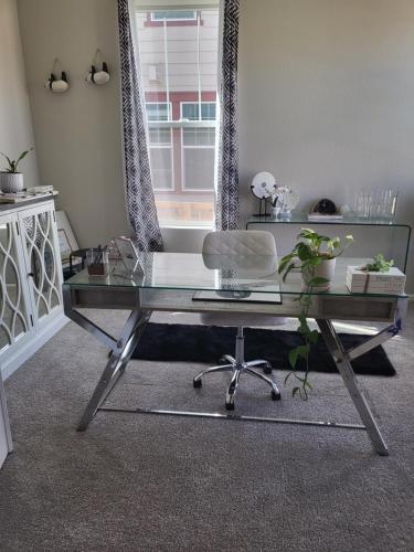 a glass desk with a chair in a room at Nile Haven in Aurora