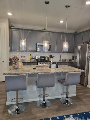 a kitchen with a counter and two bar stools at Nile Haven in Aurora