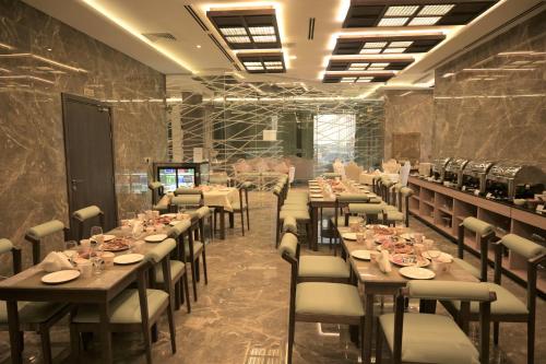 a dining room with long tables and chairs at Garden City Hotel Dubai in Dubai