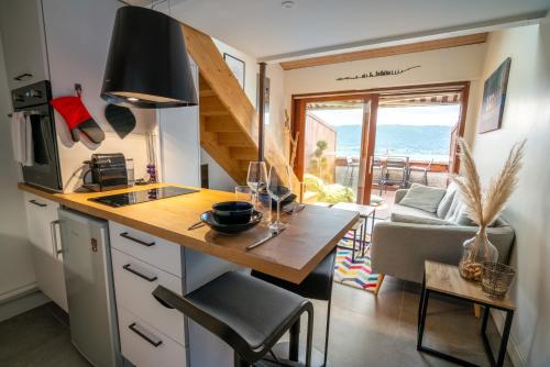a tiny kitchen with a table and a dining room at CABANA & Sunset #2 - Terrasse, Parking & Lac in Veyrier-du-Lac