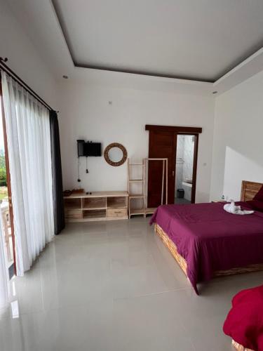 a bedroom with a bed and a large window at Bali Astetic Villa and Hot Spring in Kintamani