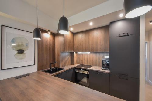 a kitchen with wooden cabinets and a wooden counter top at City Komfort Terrace in Košice