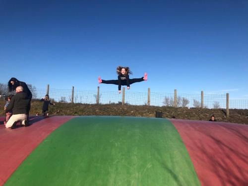 a person in the air on a trampoline at Perle Øer Maritime ferieby Ebeltoft in Ebeltoft