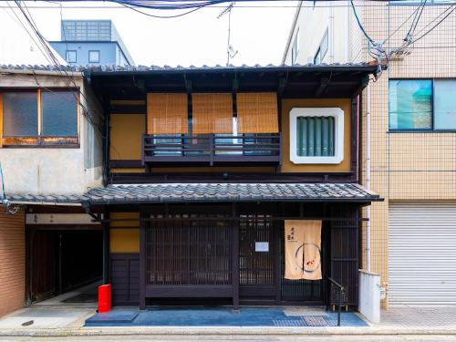 a building with a face painted on the side of it at Kyotofish·Masuya*Reformed Machiya*Gardenview Bath in Kyoto
