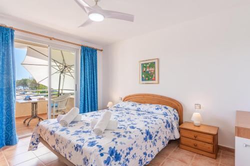 a bedroom with a bed and a balcony at Veleta ll in Pollença