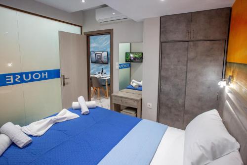 a hotel room with a blue bed and a desk at RENT HOUSE ANEMOS in Iraklitsa