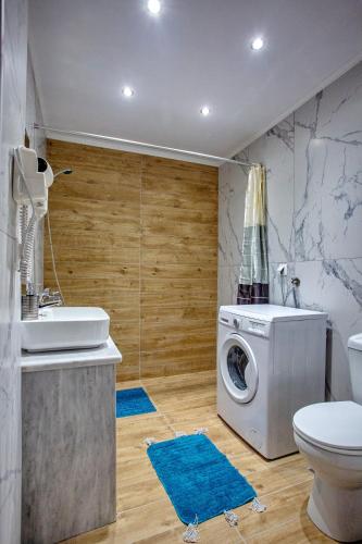 a bathroom with a washing machine and a washer at RENT HOUSE ANEMOS in Iraklitsa
