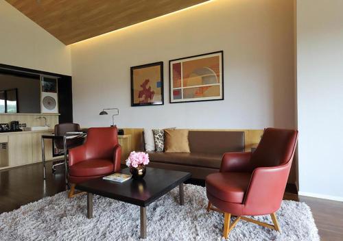 a living room with a couch and two chairs and a table at Midori Clark Hotel and Casino in Clark