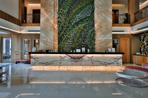 a lobby with a large green wall at Butterfly Valley Resort in Ruisui