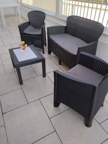 a group of chairs and a table on a patio at L'ARTE DI VENERE SUITE in Polignano a Mare
