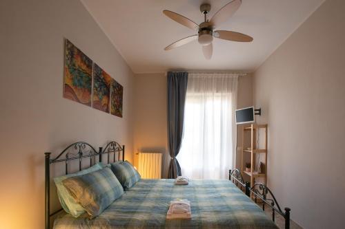 a bedroom with a bed with a ceiling fan at Il Girasole in Basciano