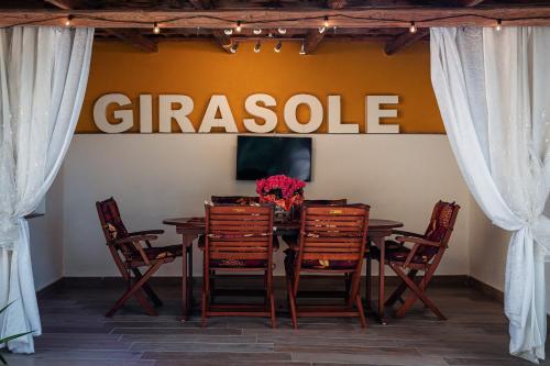 a table with chairs and a sign that readsgeistleep at Il Girasole in Basciano